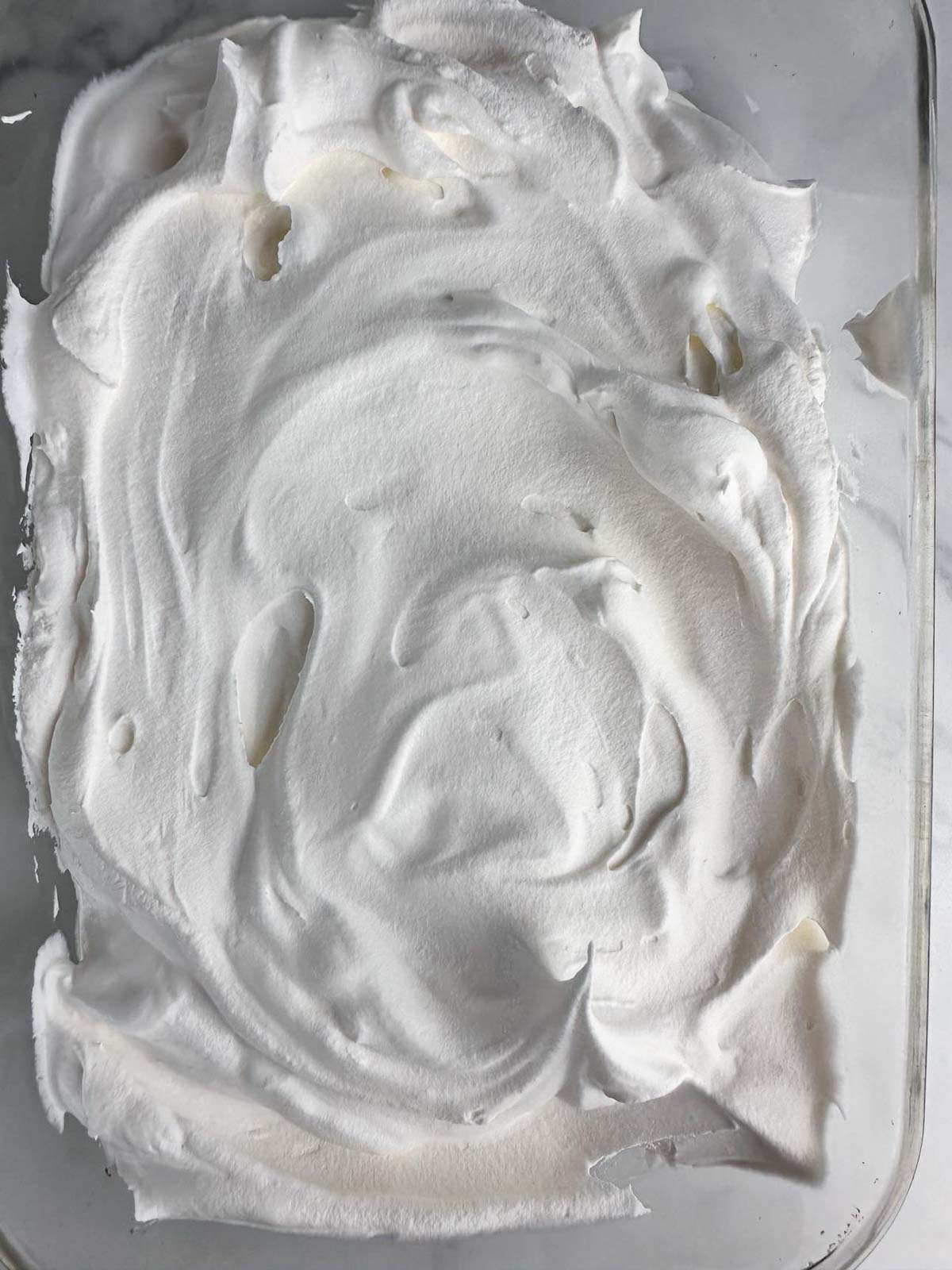 Spread the Cool Whip into a thick even layer in a casserole dish or tupperware container.
