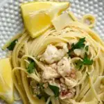 A plate of lobster scampi linguine with a text border reading lobster scampi linguine