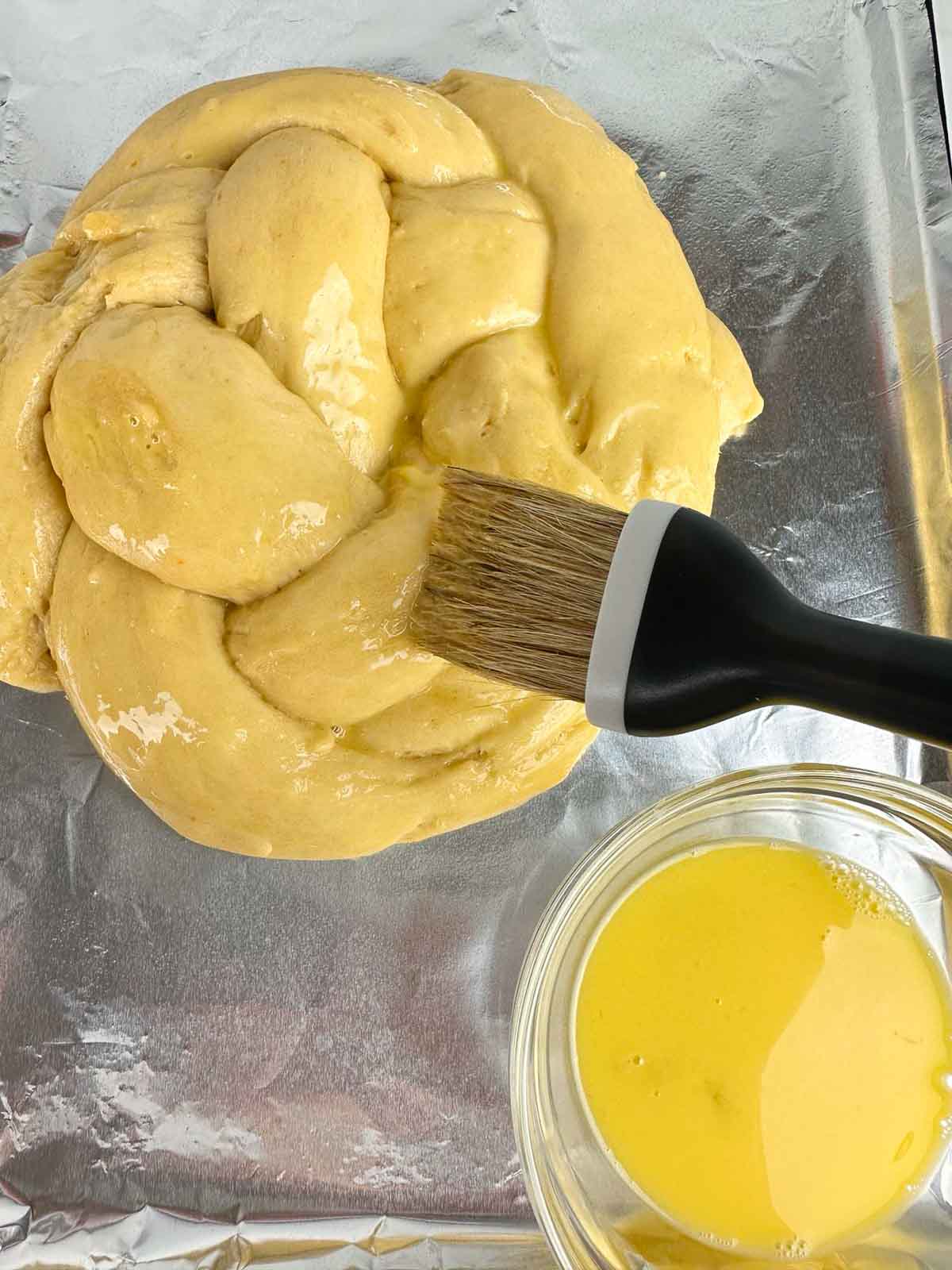 Brush the Easter bread with egg wash.