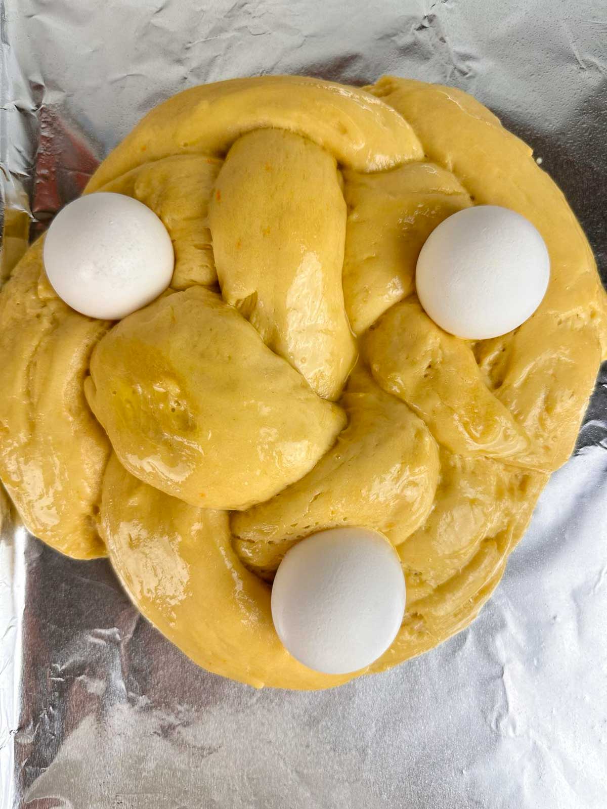 Press the eggs into the Italian Easter bread.