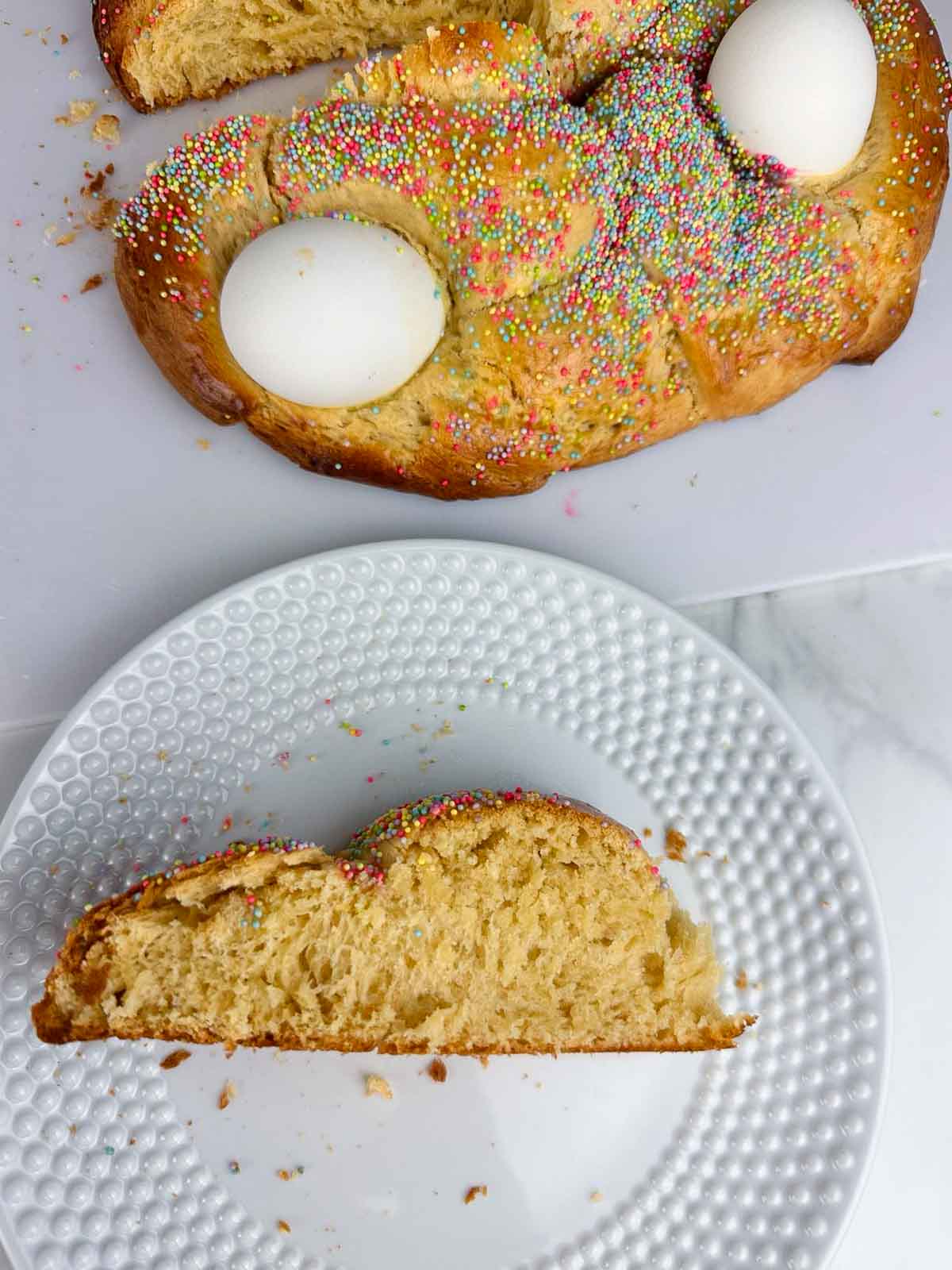 Italian Easter bread is a traditional slightly sweet brioche style perfect for the springtime holiday. This fluffy, braided bread dotted with eggs and sprinkles is a festive addition to your Easter brunch.