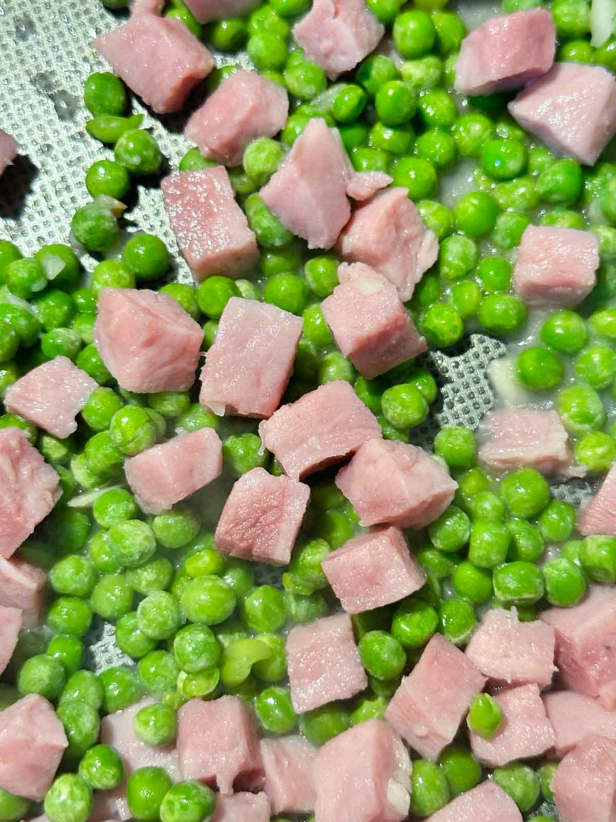 Add the peas to the pan with the seared ham and garlic butter.