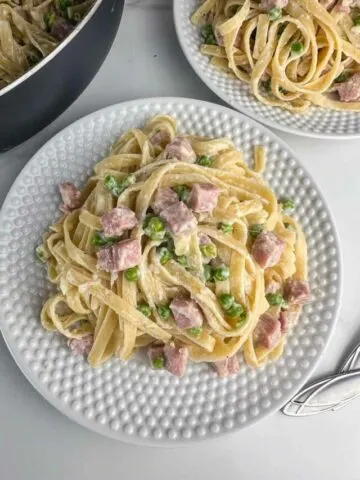 A plate of pasta with ham and peas makes delicious use of leftover ham in a hearty Italian inspired dinner.