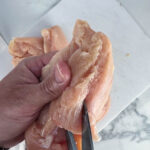 Slice the chicken breasts through the thickest part, leaving about 1/4 inch uncut.